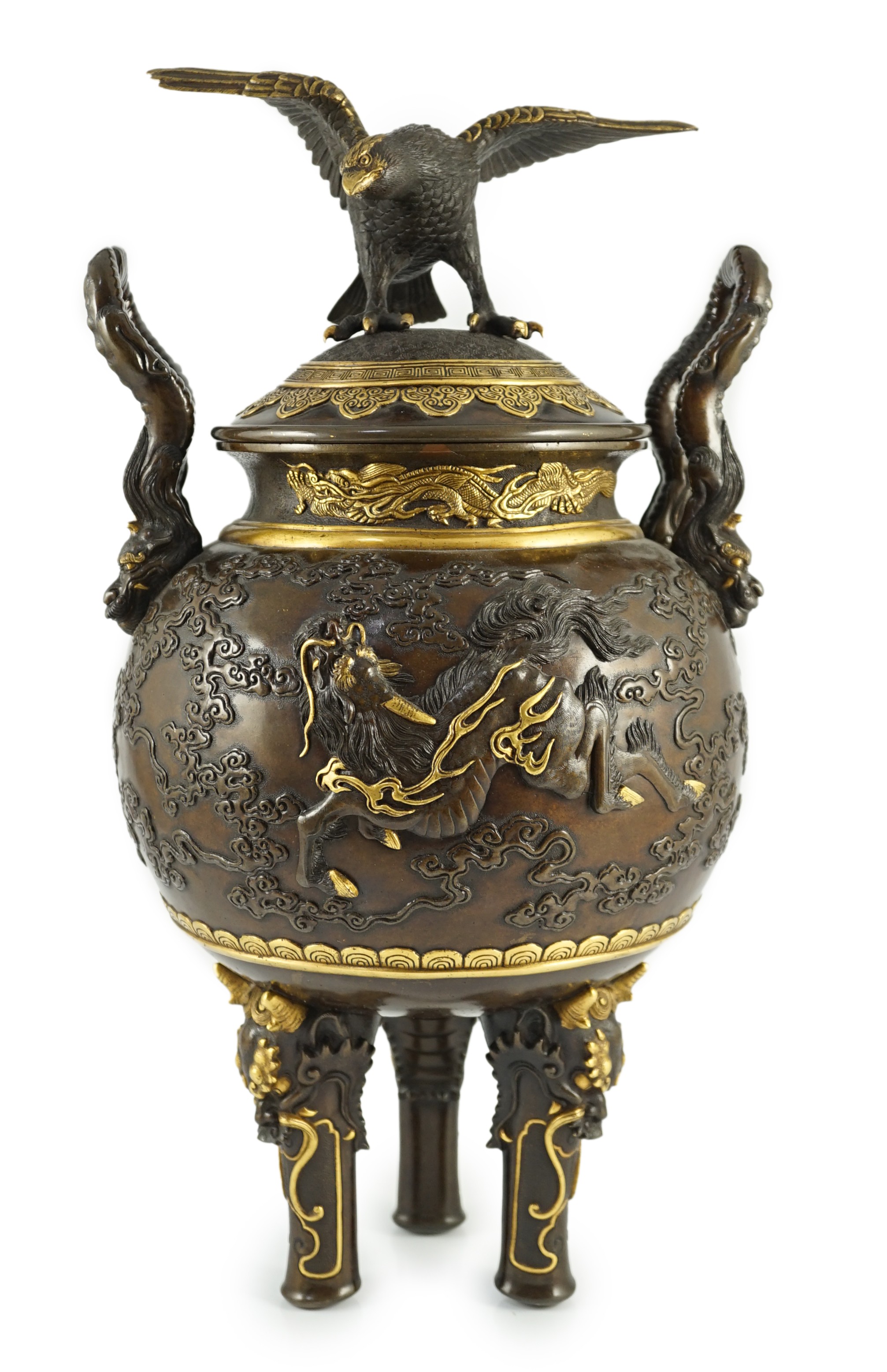 An impressive Japanese brown patinated and gilded bronze tripod koro and cover, by Miyao Eisuke, Meiji period, 42cm high, 23cm wide